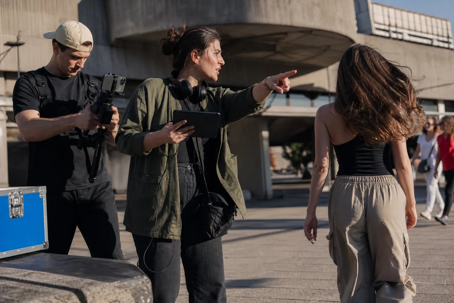 A social media manager directing a creator shoot in an outdoor Belgrade location
